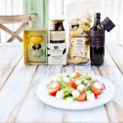 Gourmet Greek Salad ingredients styled with fresh tomatoes, cucumbers, olives, and EVOO – luxury gift experience
