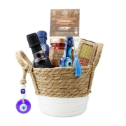 A luxury Greek gift basket filled with gourmet foods like honey, ouzo, red pepper dip, and pasta, decorated with a blue evil eye charm.